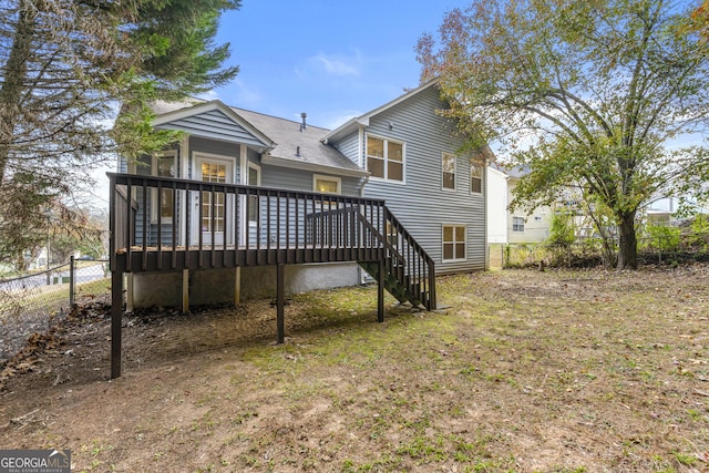 rear view of house featuring a wooden deck