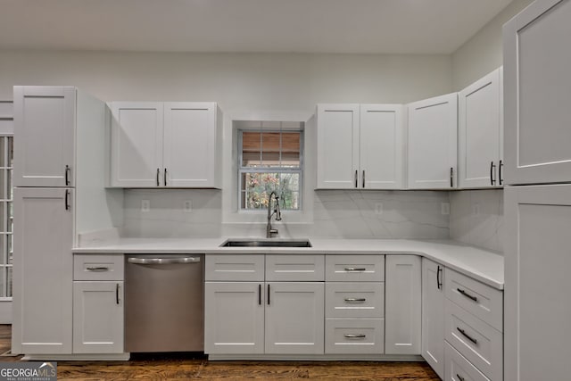 kitchen featuring white cabinetry, stainless steel dishwasher, sink, and dark hardwood / wood-style floors