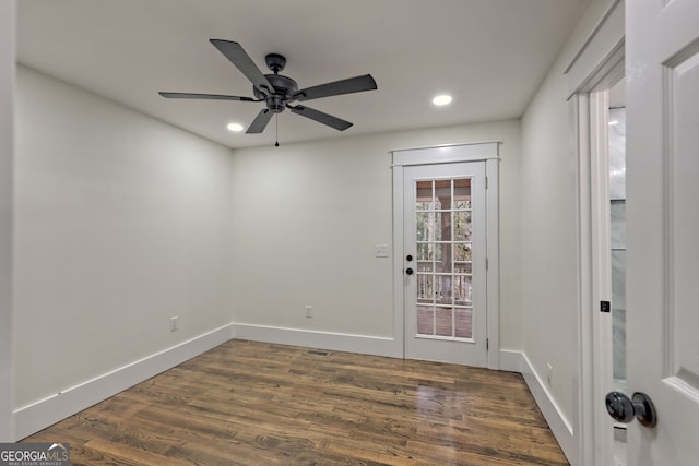 unfurnished room with dark hardwood / wood-style floors and ceiling fan