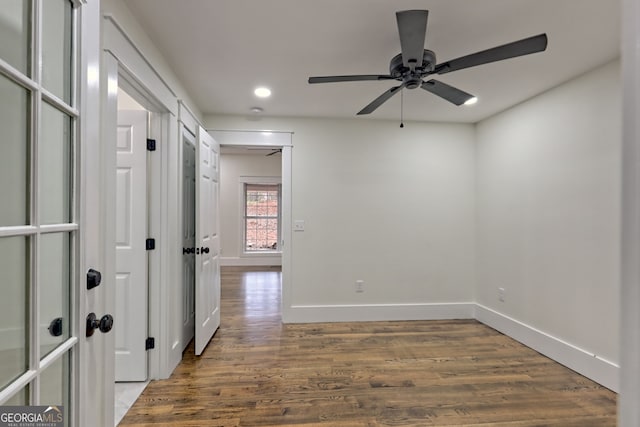 unfurnished room featuring dark hardwood / wood-style flooring and ceiling fan