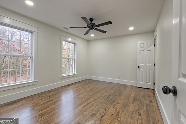 spare room with ceiling fan, dark hardwood / wood-style floors, and plenty of natural light