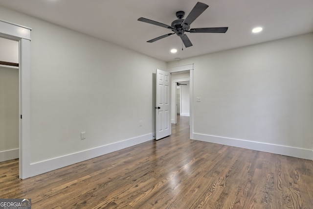 unfurnished bedroom featuring dark hardwood / wood-style flooring, ceiling fan, and a closet