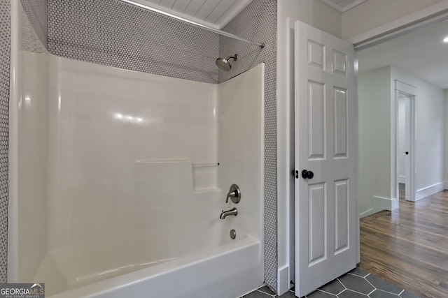 bathroom with hardwood / wood-style floors and shower / bath combination