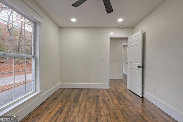 spare room with ceiling fan and dark hardwood / wood-style floors