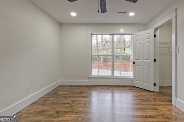 unfurnished room with dark hardwood / wood-style flooring and ceiling fan