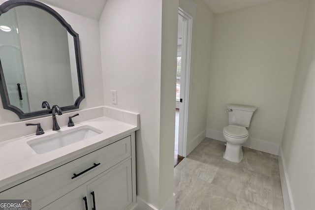 bathroom featuring toilet and vanity