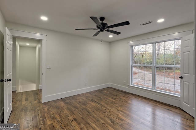 spare room featuring ceiling fan and dark hardwood / wood-style floors