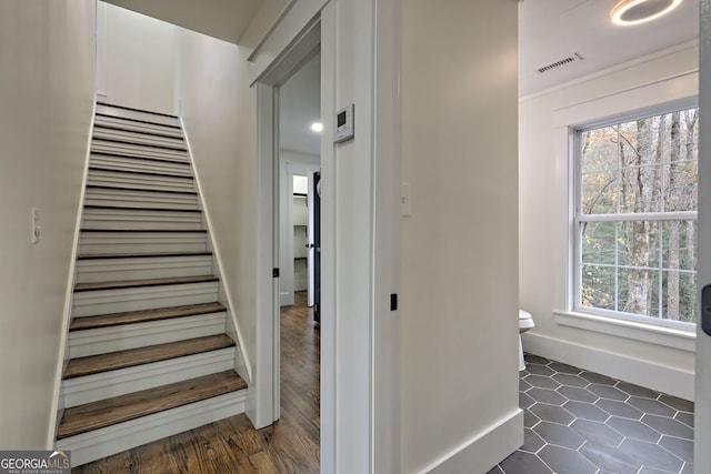 stairs featuring hardwood / wood-style floors