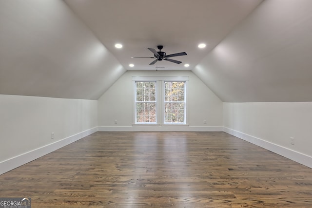 additional living space with dark hardwood / wood-style flooring, vaulted ceiling, and ceiling fan