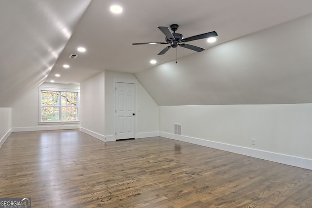 bonus room featuring dark hardwood / wood-style floors and vaulted ceiling