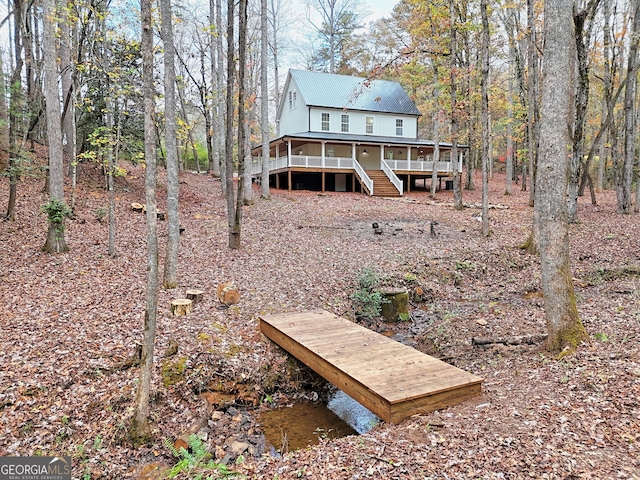 back of house with a wooden deck