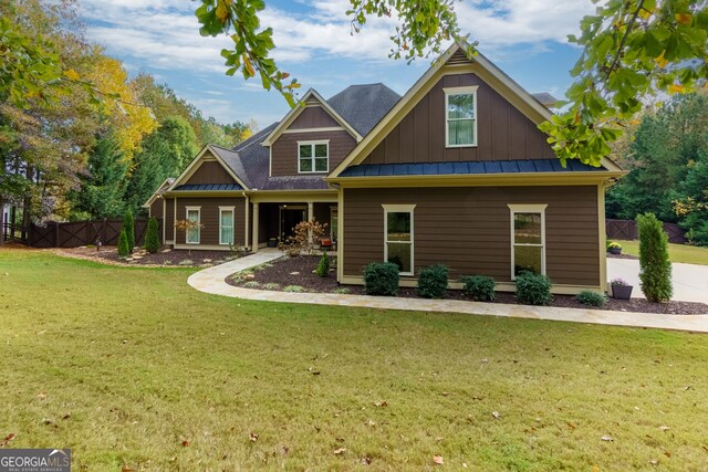 rear view of property with a lawn