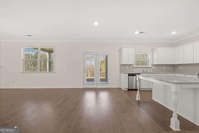 kitchen featuring dark wood-type flooring, white cabinetry, light stone counters, stainless steel dishwasher, and ornamental molding