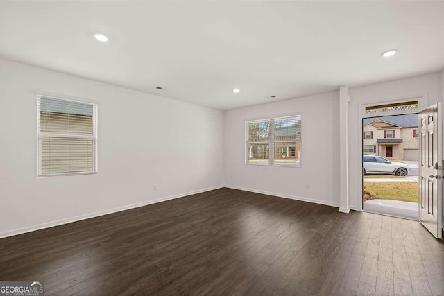 spare room with dark hardwood / wood-style floors