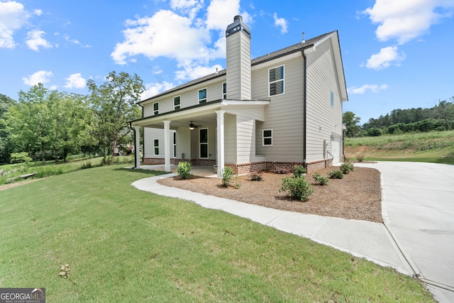 exterior space with a lawn, ceiling fan, and a porch