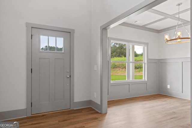 entrance foyer with wood-type flooring and an inviting chandelier