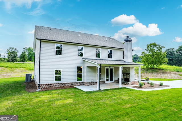 back of house featuring a lawn, a patio area, ceiling fan, and central AC unit