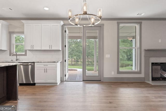 kitchen with dishwasher, white cabinetry, and a wealth of natural light