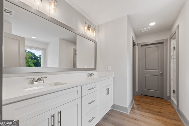 bathroom with hardwood / wood-style flooring and vanity