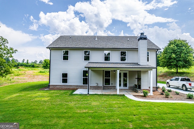 back of property featuring a lawn, a patio area, and french doors