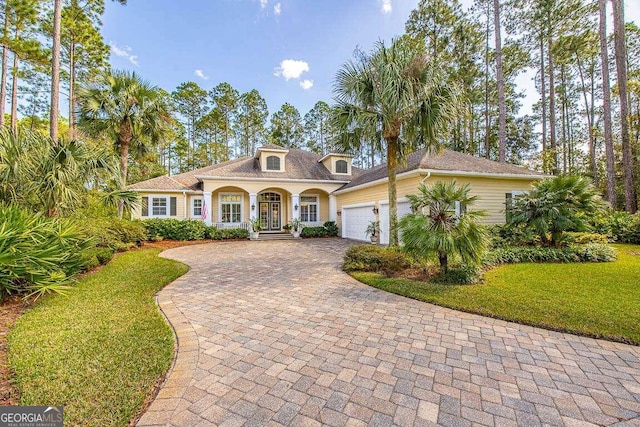 view of front of home featuring a garage and a front lawn