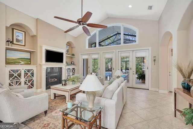 living room with high vaulted ceiling, french doors, ceiling fan, and light tile patterned flooring