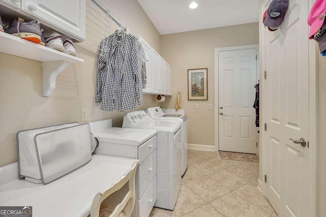 laundry area featuring independent washer and dryer, light tile patterned floors, and cabinets