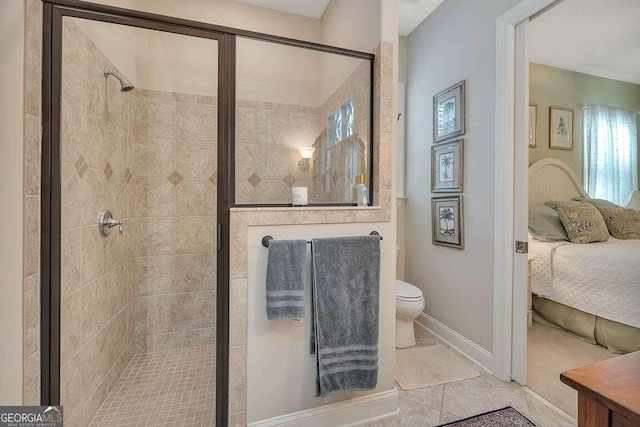 bathroom with tile patterned flooring, toilet, and walk in shower