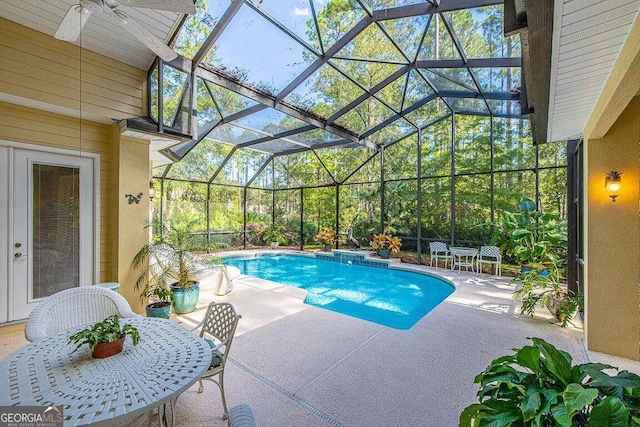 view of pool featuring a patio and glass enclosure