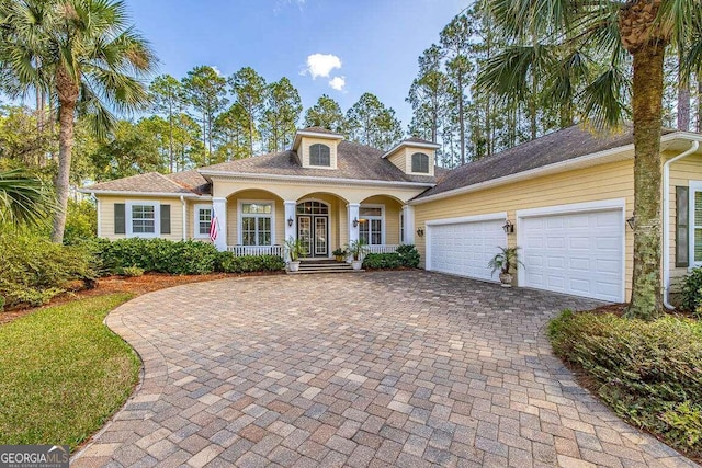 view of front of property featuring a garage and a porch