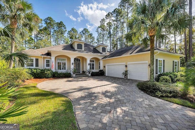 view of front of property featuring a garage and covered porch