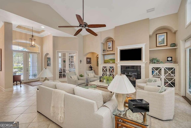 living room featuring french doors, ceiling fan, built in shelves, and light tile patterned floors