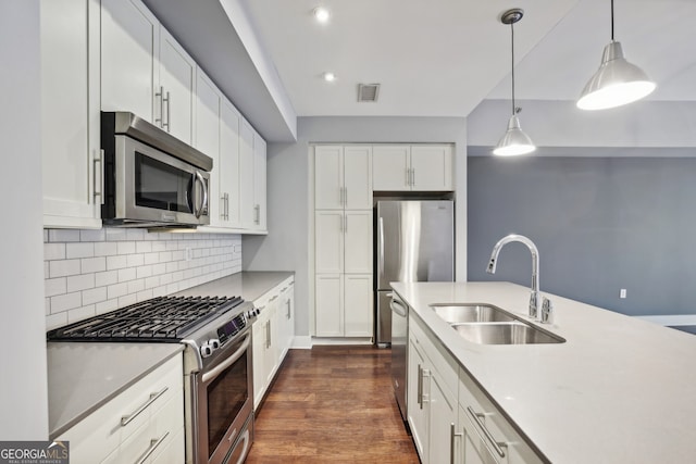 kitchen featuring dark wood-type flooring, white cabinetry, sink, and appliances with stainless steel finishes