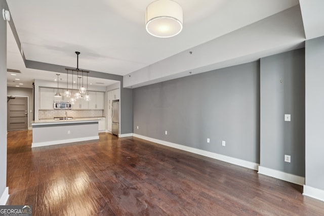 unfurnished living room featuring dark hardwood / wood-style flooring