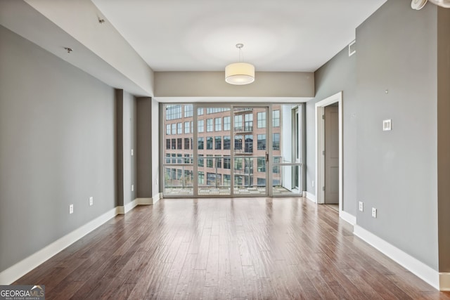 empty room with wood-type flooring