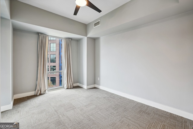 carpeted empty room with ceiling fan