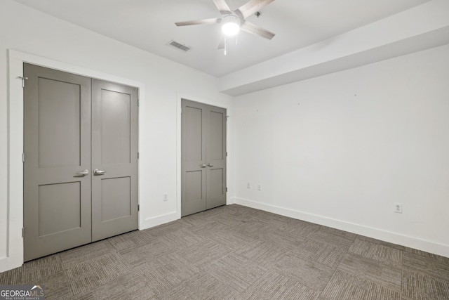 unfurnished bedroom featuring light carpet and ceiling fan