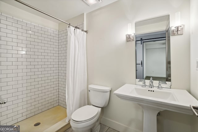 bathroom featuring toilet and a shower with curtain