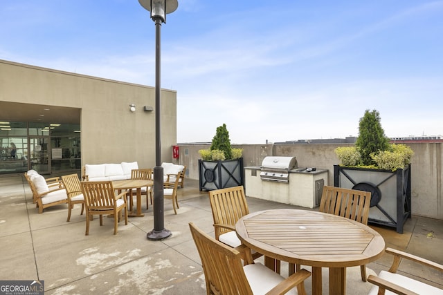 view of patio / terrace with an outdoor kitchen, an outdoor hangout area, and a grill