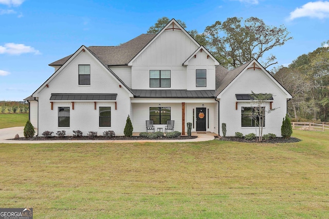 modern farmhouse style home featuring a front yard and covered porch