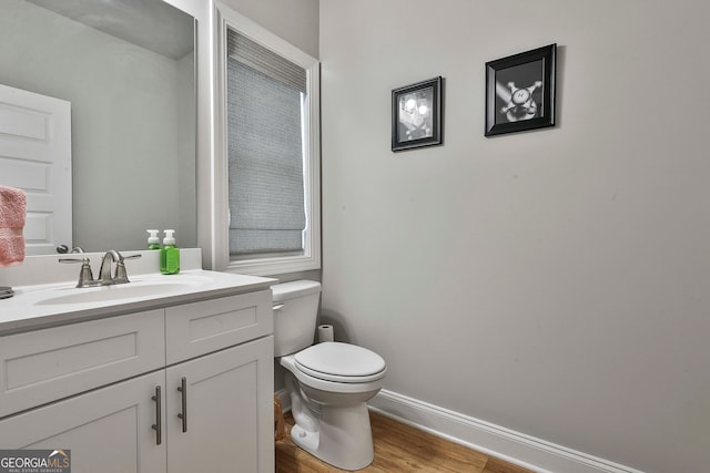 bathroom with vanity, wood-type flooring, and toilet