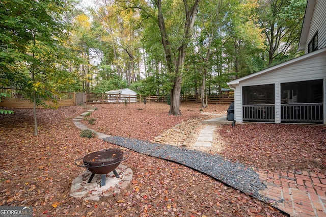 view of yard with an outdoor fire pit