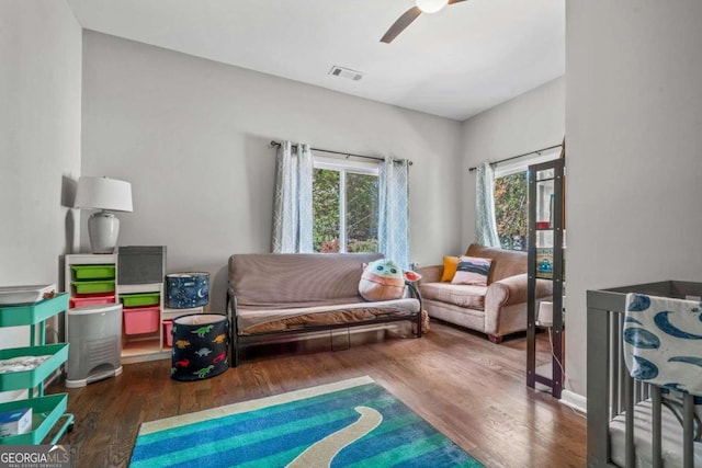 living room with dark wood-type flooring and ceiling fan