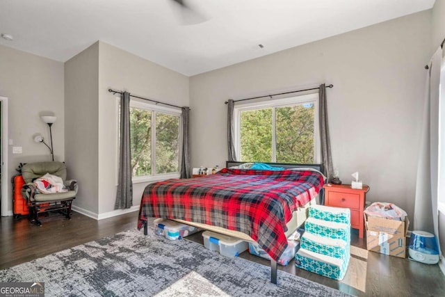 bedroom with dark wood-type flooring