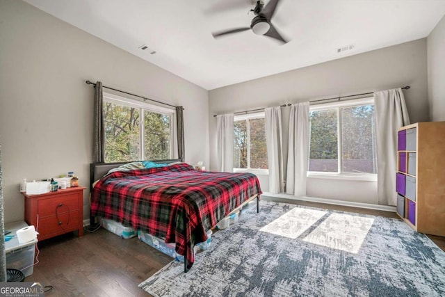 bedroom with vaulted ceiling, ceiling fan, and dark hardwood / wood-style flooring