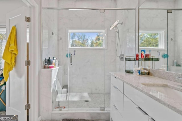 bathroom with an enclosed shower and vanity