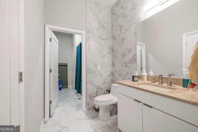 bathroom with toilet, vanity, and tile walls