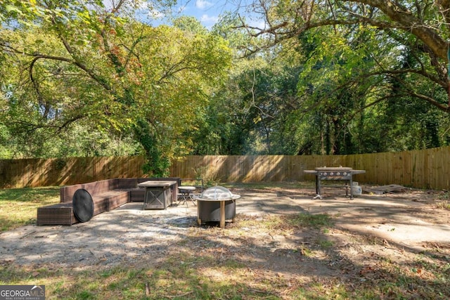 view of yard featuring an outdoor fire pit