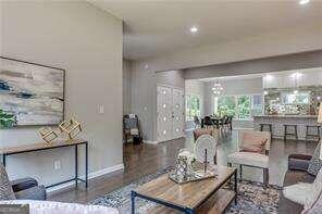 living room with dark hardwood / wood-style flooring and a chandelier