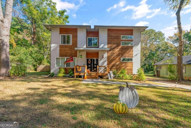 contemporary house featuring a front lawn